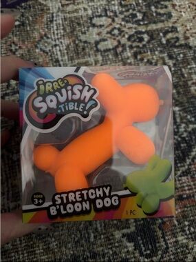 Irre-squish-able Neon orange balloon dog.